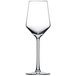A clear wine glass with a long stem on a white background.