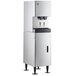 A stainless steel Hoshizaki ice maker and water dispenser with a black rectangular machine and two water dispensers.