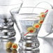 Two Libbey Cosmopolitan cocktail glasses with olives on the rim.