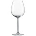 A close-up of a clear Schott Zwiesel wine glass with a long stem.