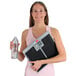 A woman holding a Cardinal Detecto SlimTALKXL digital scale and a bottle of water.