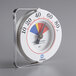 A white round Comark cooler wall thermometer with a red and blue dial.