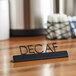 A black American Metalcraft tabletop sign with "Decaf" in laser-cut letters.