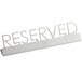 A white stainless steel American Metalcraft tabletop sign with "Reserved" in laser-cut letters.