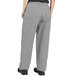 Uncommon Chef houndstooth chef pants in grey and white with a person wearing them.