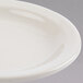 A close-up of a Homer Laughlin ivory narrow rim china plate.