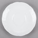 A Tuxton bright white china demitasse saucer with a circular edge.
