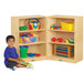 A child sitting next to a Jonti-Craft slim wood storage cabinet with colorful building blocks.