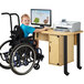 A young boy in a wheelchair using a Jonti-Craft children's computer lab table.