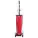 A red Sanitaire TRADITION upright vacuum cleaner with a bag.