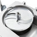 A Robot Coupe CL55 food processor with a lid on top and circular silver discs inside.
