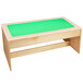 A wooden table with a green top.