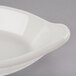 A Hall China oval rarebit dish in white on a gray surface.