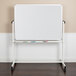 A Flash Furniture whiteboard with a white metal frame on wheels.