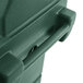 A close-up of a green plastic box with a handle.
