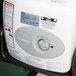 A white and grey Cambro CamKiosk portable self-contained hand sink with a dial.