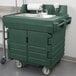 A green plastic Cambro portable self-contained hand sink cart with a faucet.