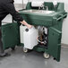 A person pushing a green Cambro CamKiosk with a sink.