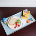 A Cambro sky blue dietary tray with food on it.