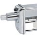 A close-up of a stainless steel KitchenAid pasta cutter attachment.