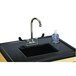 A Jonti-Craft mobile sink with a plastic sink and black faucet on a black surface.