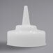 A white plastic cap with a pointy cone tip.