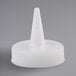 A white plastic cap with a cone on top.