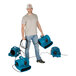 A man holding a blue XPOWER air mover with black handles.
