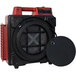 A red XPOWER commercial air purifier on a black speaker.