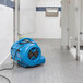 A blue XPOWER air blower on the floor.