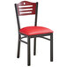 A black metal Lancaster Table & Seating bistro chair with red vinyl seat and mahogany wood back.