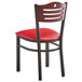 A Lancaster Table & Seating black metal bistro chair with red vinyl seat.