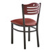 A Lancaster Table & Seating black bistro chair with a burgundy cushion.
