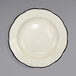 An ivory stoneware pasta bowl with a black rim.