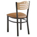 A Lancaster Table & Seating black bistro chair with a natural wood seat and brown vinyl cushion.