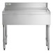 A Regency stainless steel underbar drainboard on a stainless steel counter.