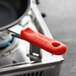 A red Choice silicone pan handle sleeve on a pan handle.