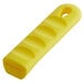 A yellow silicone pan handle sleeve with a hole in the end.