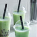A group of green drinks with Choice black pointed straws.