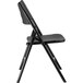 A National Public Seating black metal folding chair with black plastic seat and back.