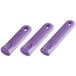 A close-up of a group of purple silicone pan handle sleeves.