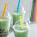 Three green drinks with Choice neon straws on a white background.