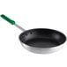 A close-up of a Choice aluminum non-stick fry pan with a green handle.