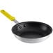 A Choice aluminum non-stick frying pan with a yellow handle.