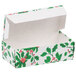 A white candy box with green and red holly leaves and berries on it.