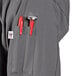 A close-up of a Uncommon Chef long sleeve chef coat pocket.