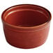 An Acopa Keystone Sedona Orange stoneware ramekin with a brown bowl and brown rim.
