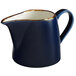 An Acopa Keystone blue and white stoneware creamer with gold trim.