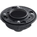 A black metal Zurn floor drain with a hole for a black plastic pipe fitting and nuts and bolts.