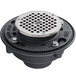 A black Zurn floor drain with a silver round metal cover.